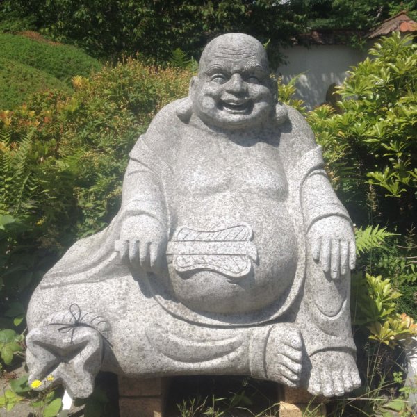 happy japanese buddha in granite