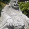 happy japanese buddha in granite