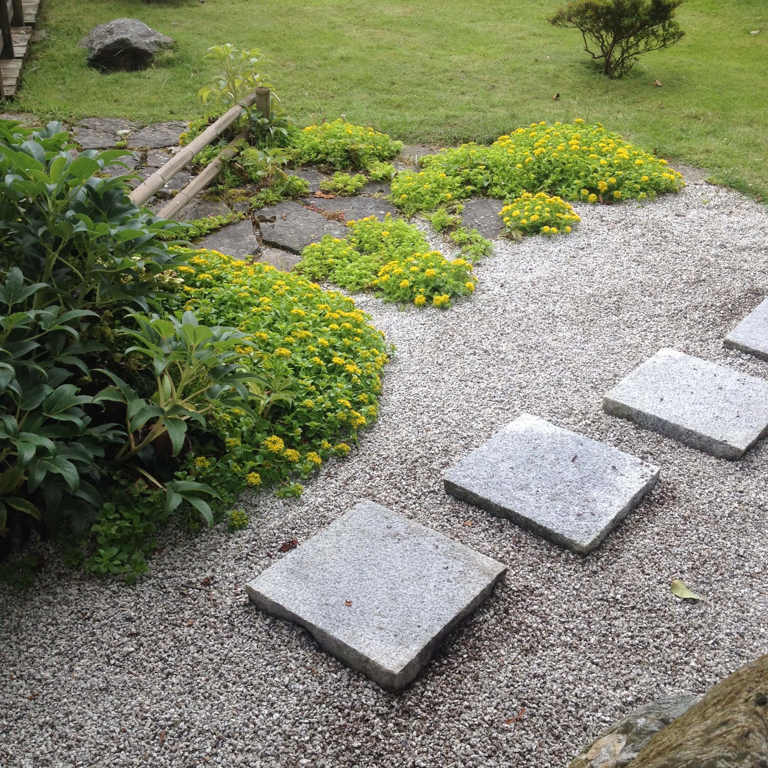 Square format stepping stones from natural silver grey granite for gardens