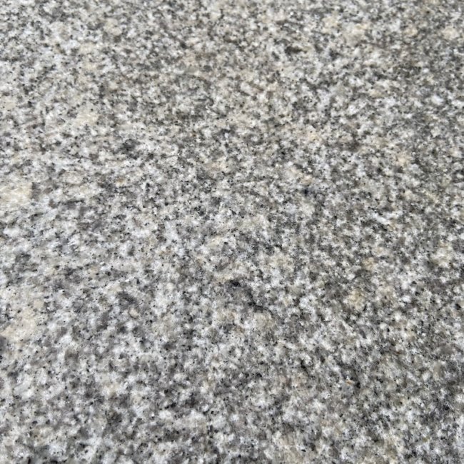 Square format stepping stones from natural silver grey granite for gardens